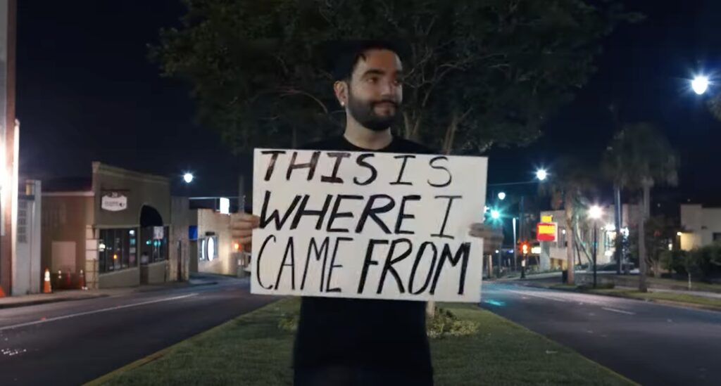 Jeremy McKinnon, lead singer of A Day to Remember, holds up a sign during filming of City of Ocala.