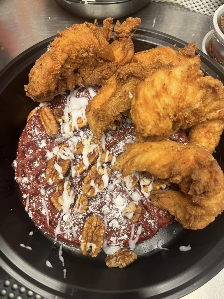Specialty waffle with pecans and fried chicken at The Waffle Shop