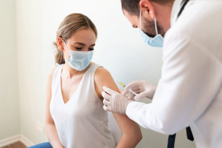 Vaccine shot administered to young woman